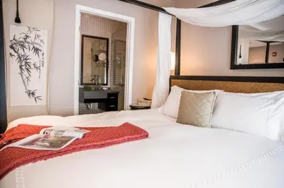 a bedroom with a white bed with a book on it at Cadet Hotel in Miami Beach