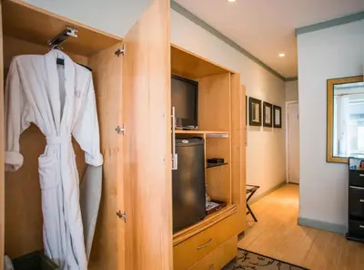 a robe hanging on a door in a room at Cadet Hotel in Miami Beach