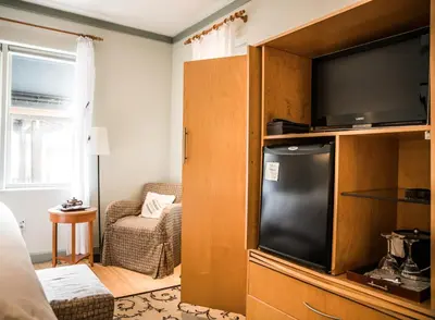 a living room with a large flat screen tv at Cadet Hotel in Miami Beach