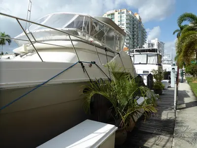 a boat is parked next to a dock at PlayaBlanco Suites in Fort Lauderdale