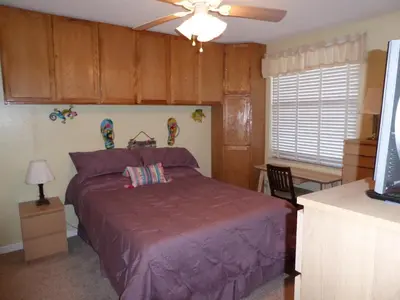 a bedroom with a bed and a ceiling fan at PlayaBlanco Suites in Fort Lauderdale