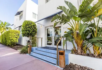 a house with blue stairs in front of a building at Oceanside Hotel and Suites in Miami Beach