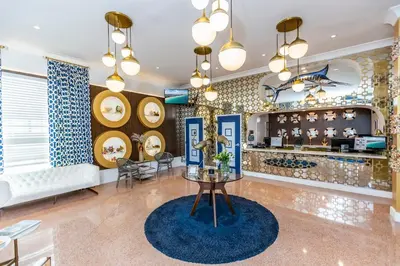 a lobby with a table and a bar at Oceanside Hotel and Suites in Miami Beach