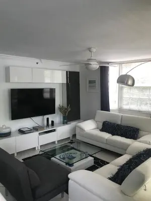 a living room with a couch and a tv at The Nautical! Amazing 3Bed 2Bath Apartment at Aventura Yacht Club in Aventura