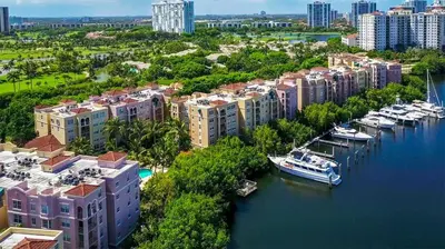 an aerial view of a city with boats in a harbor at The Nautical! Amazing 3Bed 2Bath Apartment at Aventura Yacht Club in Aventura