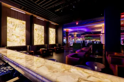 a bar at a restaurant with purple chairs and a counter at Miccosukee Casino & Resort in Miami