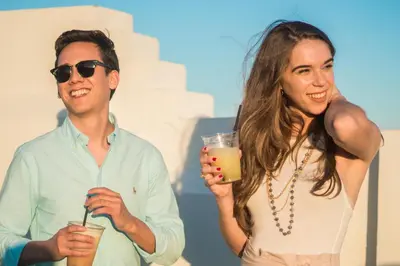 a man and a woman holding drinks in their hands at Clevelander Hotel in Miami Beach