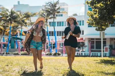 two women walking on the grass in a field at Clevelander Hotel in Miami Beach