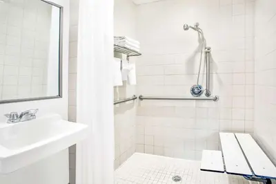 a white bathroom with a sink and a shower at Lexington by Hotel RL Miami Beach in Miami Beach