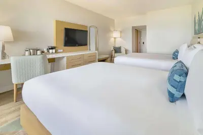 a hotel room with two beds and a television at Radisson Resort Miami Beach in Miami Beach