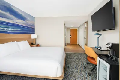 a hotel room with a bed and a desk at Courtyard by Marriott Oceanside Fort Lauderdale Beach in Fort Lauderdale