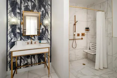 a bathroom with a sink and a shower at Cadillac Hotel & Beach Club, Autograph Collection in Miami Beach