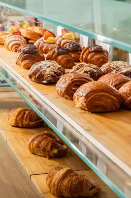 a display case filled with lots of different types of pastries at Cadillac Hotel & Beach Club, Autograph Collection in Miami Beach