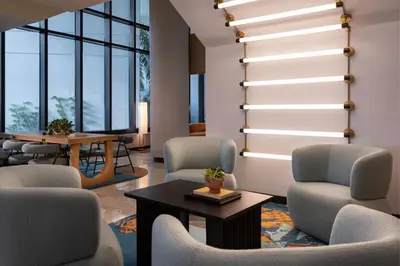 a lobby with chairs and a table and windows at Miami Marriott Biscayne Bay in Miami