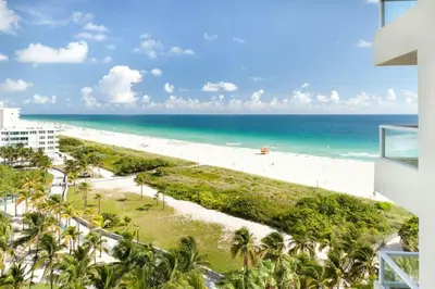 a view of the beach from the balcony of a resort at Marriott Stanton South Beach in Miami Beach