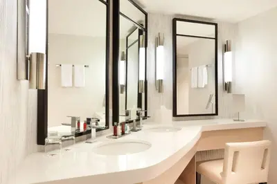 a bathroom with two sinks and a large mirror at Marriott Stanton South Beach in Miami Beach
