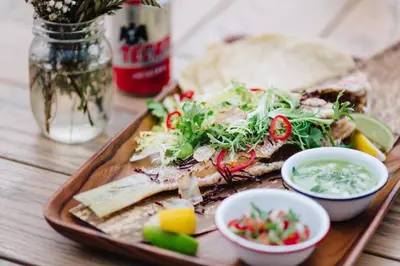 a plate of food with a sandwich and some salsa at Marriott Stanton South Beach in Miami Beach