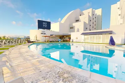 a swimming pool in front of a building at Nuvo Suites Hotel - Miami Doral in Miami