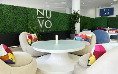 a room with chairs and a white table and a table at Nuvo Suites Hotel - Miami Doral in Miami
