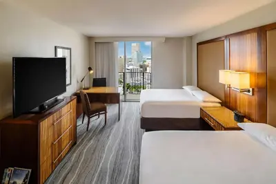 a hotel room with two beds and a flat screen tv at Hyatt Regency Miami in Miami