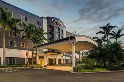 a hotel with a parking lot in front of a building at Courtyard by Marriott Miami West/FL Turnpike in Miami
