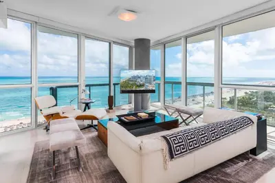 a living room with large windows and the ocean at Oceanfront Private Condo at The Setai -2208 in Miami Beach