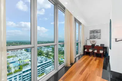 a room with large windows and a desk with a view at Oceanview Private Condo at The Setai -2402 in Miami Beach