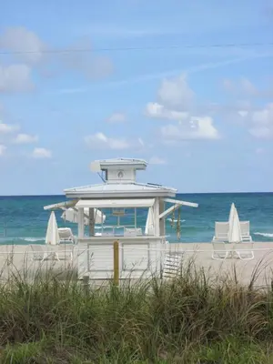 a lifeguard station on a beach with two chairs at Ocean Blue in Miami Beach