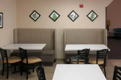 a dining room with two tables and chairs at Sleep Inn & Suites Ft Lauderdale International Airport in Dania Beach