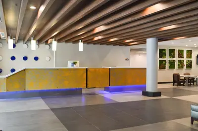 a lobby with a reception desk and chairs at Best Western Plus Ft Lauderdale Hollywood Airport Hotel in Hollywood