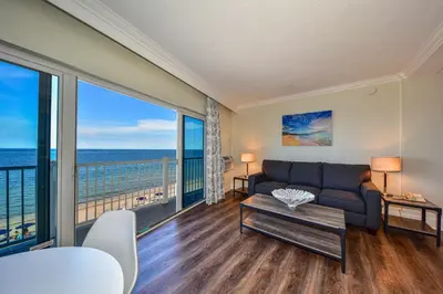 a living room with a couch and a view of the ocean at Sun Tower Hotel & Suites on the Beach in Fort Lauderdale