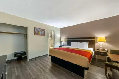 a hotel room with a bed and a desk at Fort Lauderdale Gardens Inn & Suites Ft Lauderdale International Airport in Hollywood