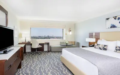 a hotel room with a bed and a flat screen tv at InterContinental Miami by IHG in Miami
