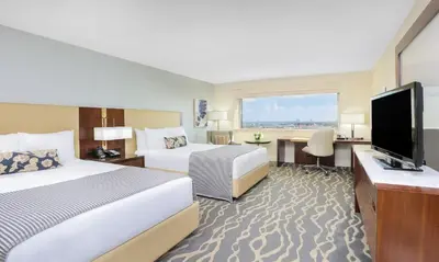 a hotel room with two beds and a flat screen tv at InterContinental Miami by IHG in Miami