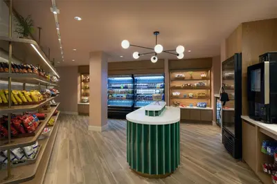 a grocery store aisle with a green and white counter at Sonesta Miami Airport in Miami