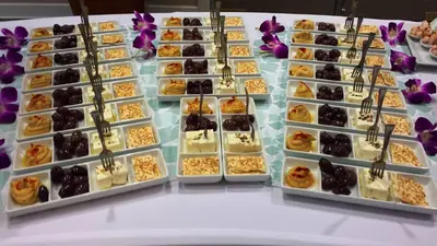 a display case filled with different types of desserts at Holiday Inn Miami Beach-Oceanfront by IHG in Miami Beach