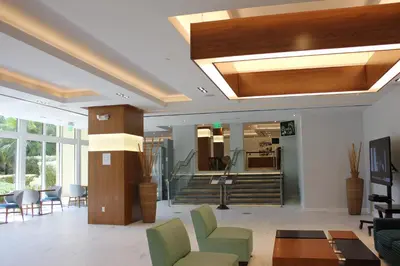 a living room with a ceiling with a light at Holiday Inn Miami Beach-Oceanfront by IHG in Miami Beach