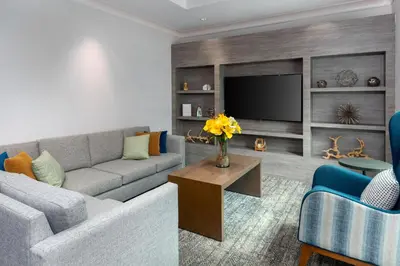 a living room with a couch and a tv at Staybridge Suites Miami Doral Area by IHG in Miami