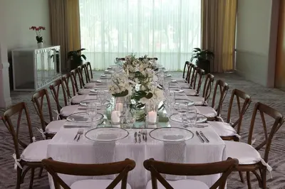 a long table with white tablecloths and flowers on it at InterContinental At Doral Miami by IHG in Miami
