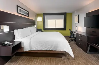 a hotel room with a bed and a desk at Holiday Inn Express Miami Airport Doral Area by IHG in Miami