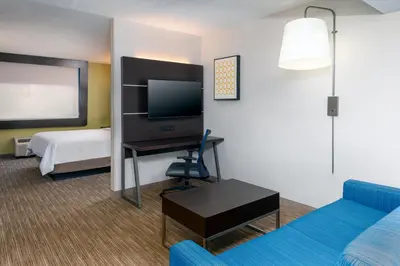 a hotel room with a bed and a flat screen tv at Holiday Inn Express Miami Airport Doral Area by IHG in Miami
