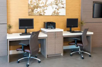 an office with two desks with two monitors and two chairs at Holiday Inn Miami-Doral Area by IHG in Miami