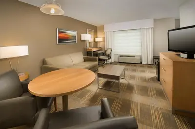 a living room with a couch and a table at Holiday Inn Miami-Doral Area by IHG in Miami