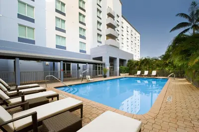 a swimming pool in front of a building at Holiday Inn Miami-Doral Area by IHG in Miami