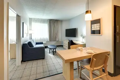 a living room with a couch and a table in a room at Sonesta Simply Suites Miami Airport Doral in Miami