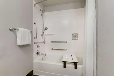 a white bathroom with a shower and a bath tub at Sonesta Simply Suites Miami Airport Doral in Miami
