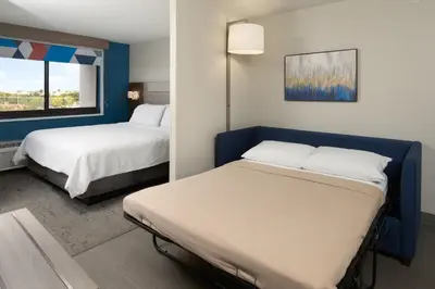 a hotel room with two beds and a window at Holiday Inn Express Hotel & Suites Kendall East-Miami by IHG in Kendall