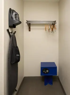 a room with a helmet and a bag on a wall at Holiday Inn Express Hotel & Suites Kendall East-Miami by IHG in Kendall