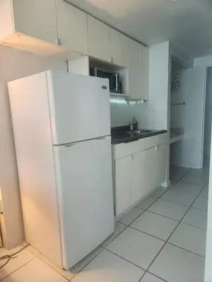 a white kitchen with a white refrigerator in it at L&D Vacations Rentals in Miami Beach