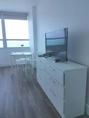 a living room with a tv on a dresser at L&D Vacations Rentals in Miami Beach